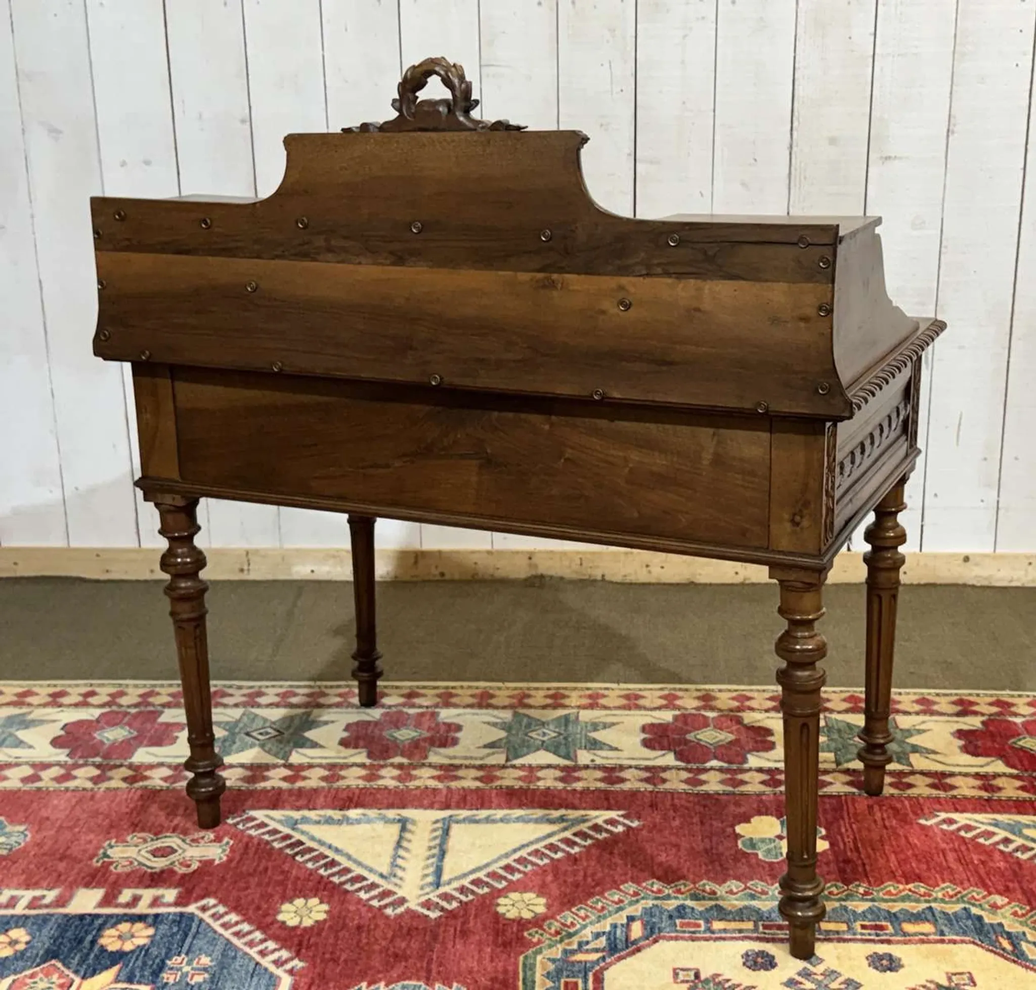 Louis XVI style desk from the late 19th century in walnut with a leather top.