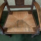 Antique armchair in carved wood with a straw seat.