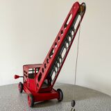Red sheet metal construction crane dating from the 60s with manual mechanism
