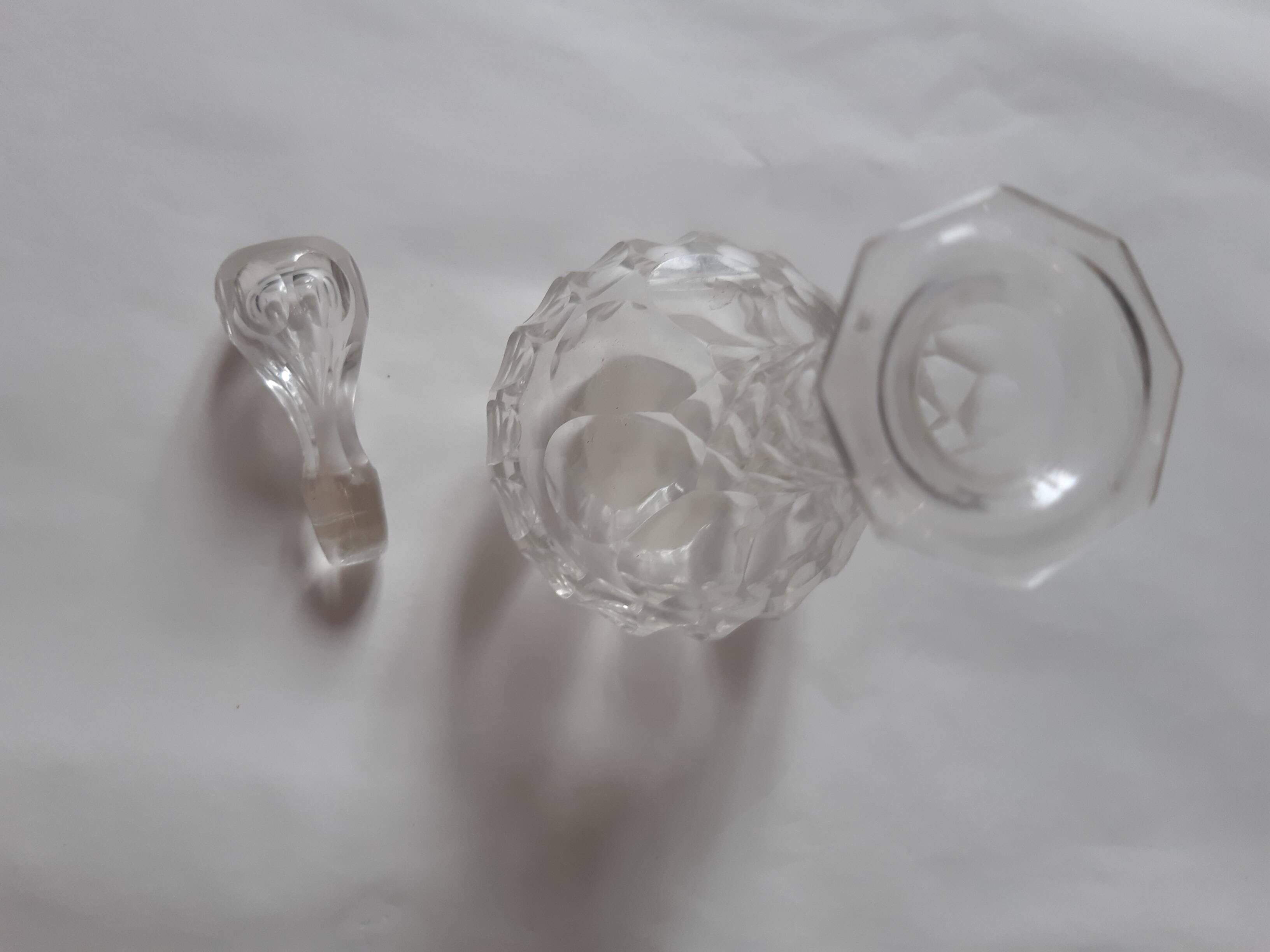Cut crystal oil bottle with its crystal stopper.