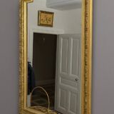 Large antique mirror from the Napoléon III era, finely carved and gilded with gold leaf.