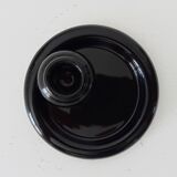 Vintage black ceramic candle holder on a bowl