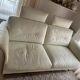 Ecru leather 2.5-seater sofa with walnut armrests.
