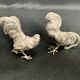 Showcase objects, two 20th century metal rooster and hen subjects