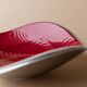 Red enameled steel bowl with textured interior and silver exterior; vintage Italian 1970s design