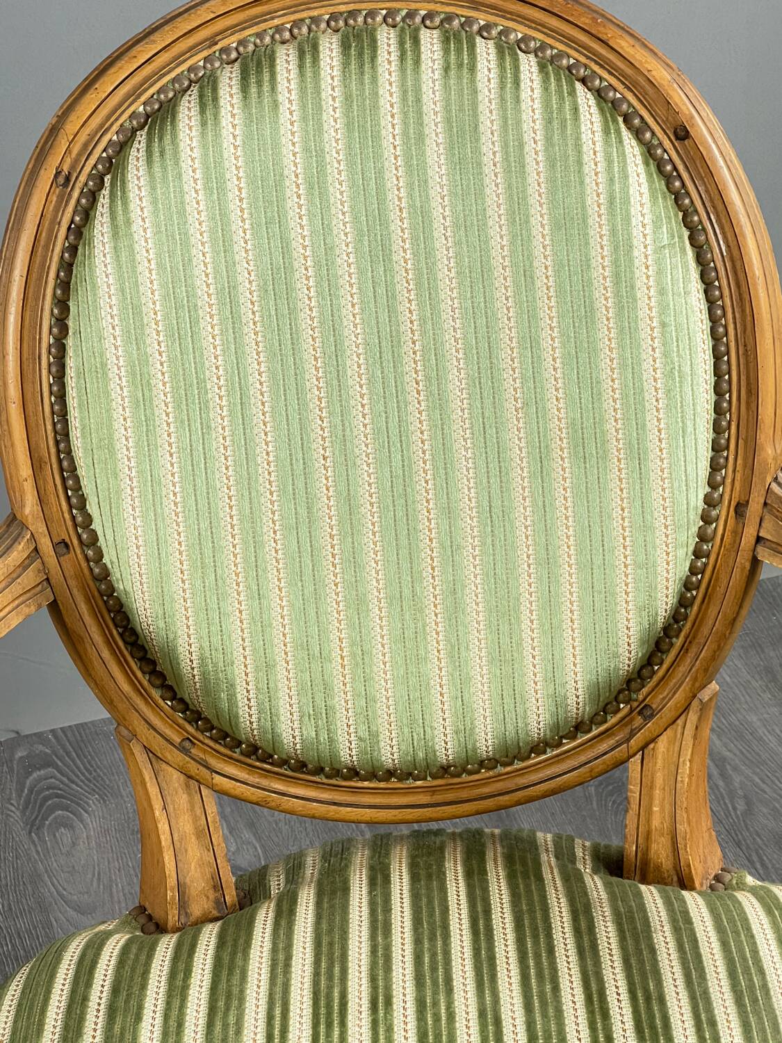 Pair of Louis XVI style armchairs in striped green fabric, 20th century.