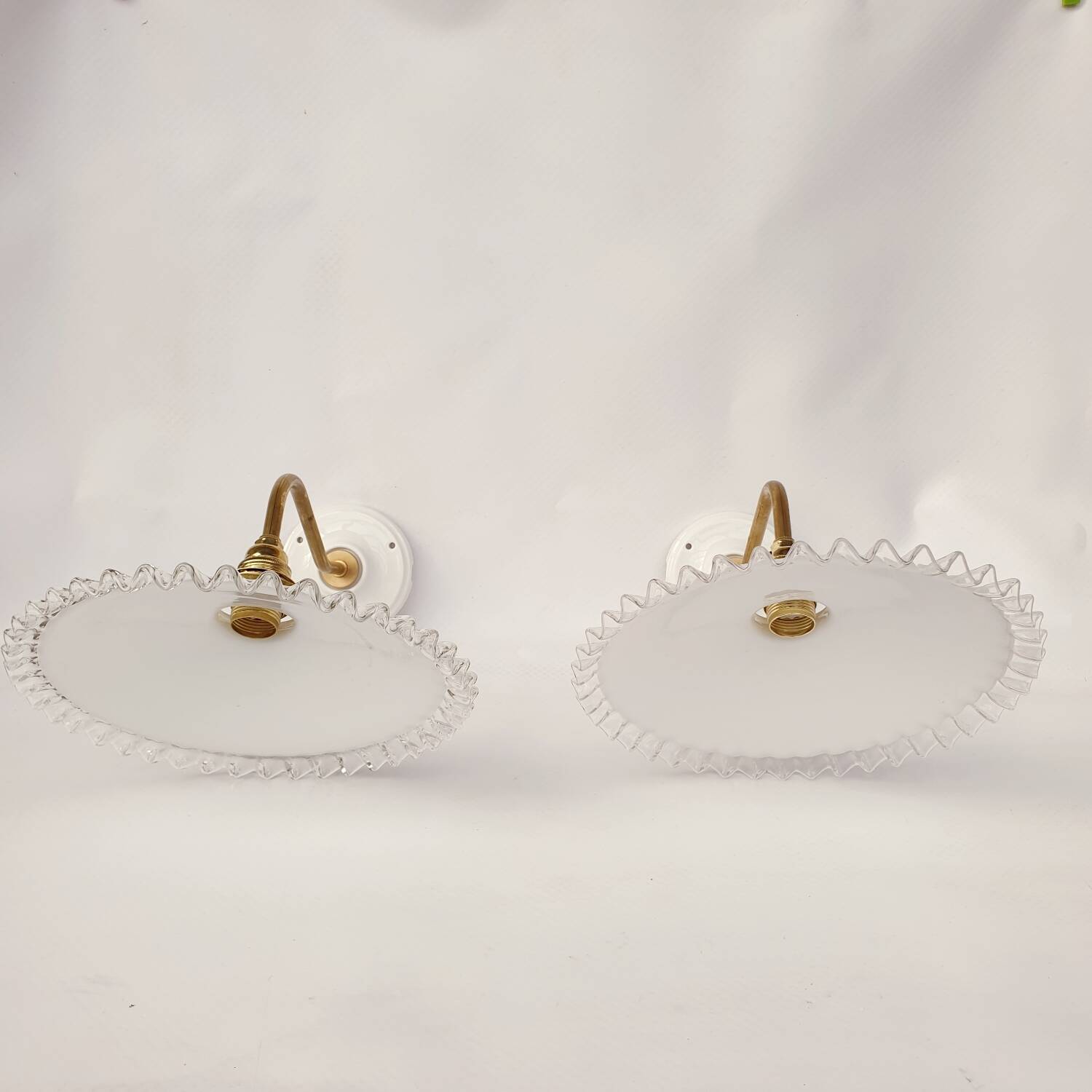 Swan neck sconces in serrated opaline