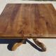 Old walnut table with a central leg.