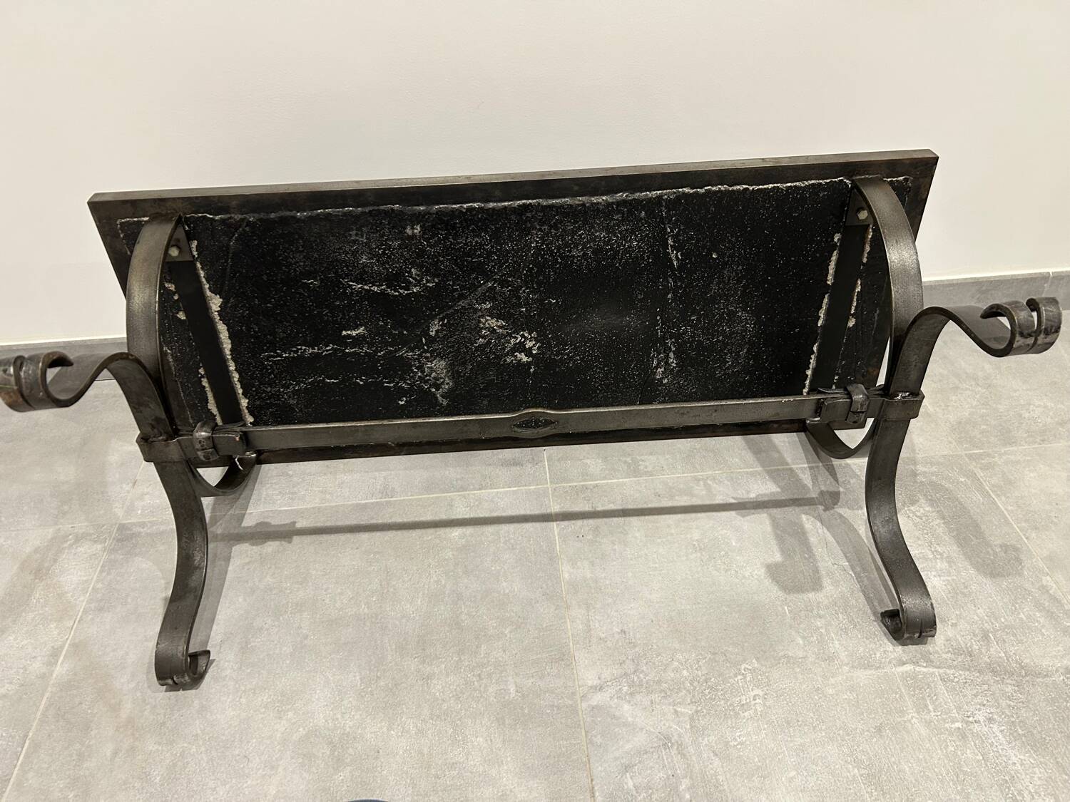 Brutalist-style coffee table made of mixed wrought iron and stone.