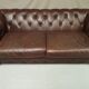 Three seater brown leather chesterfield sofa