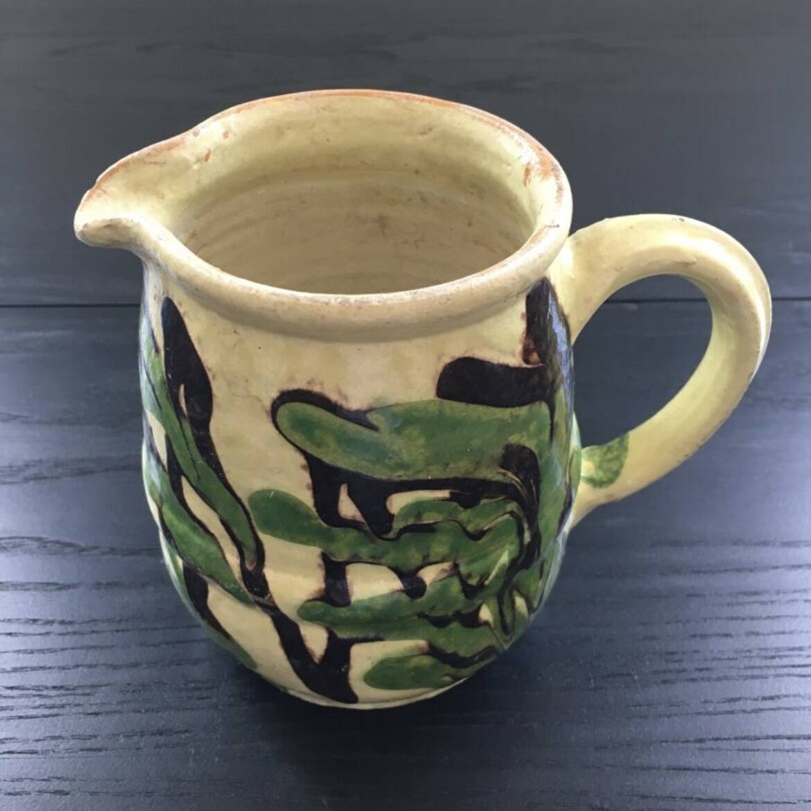 Antique pitcher of mixed earth