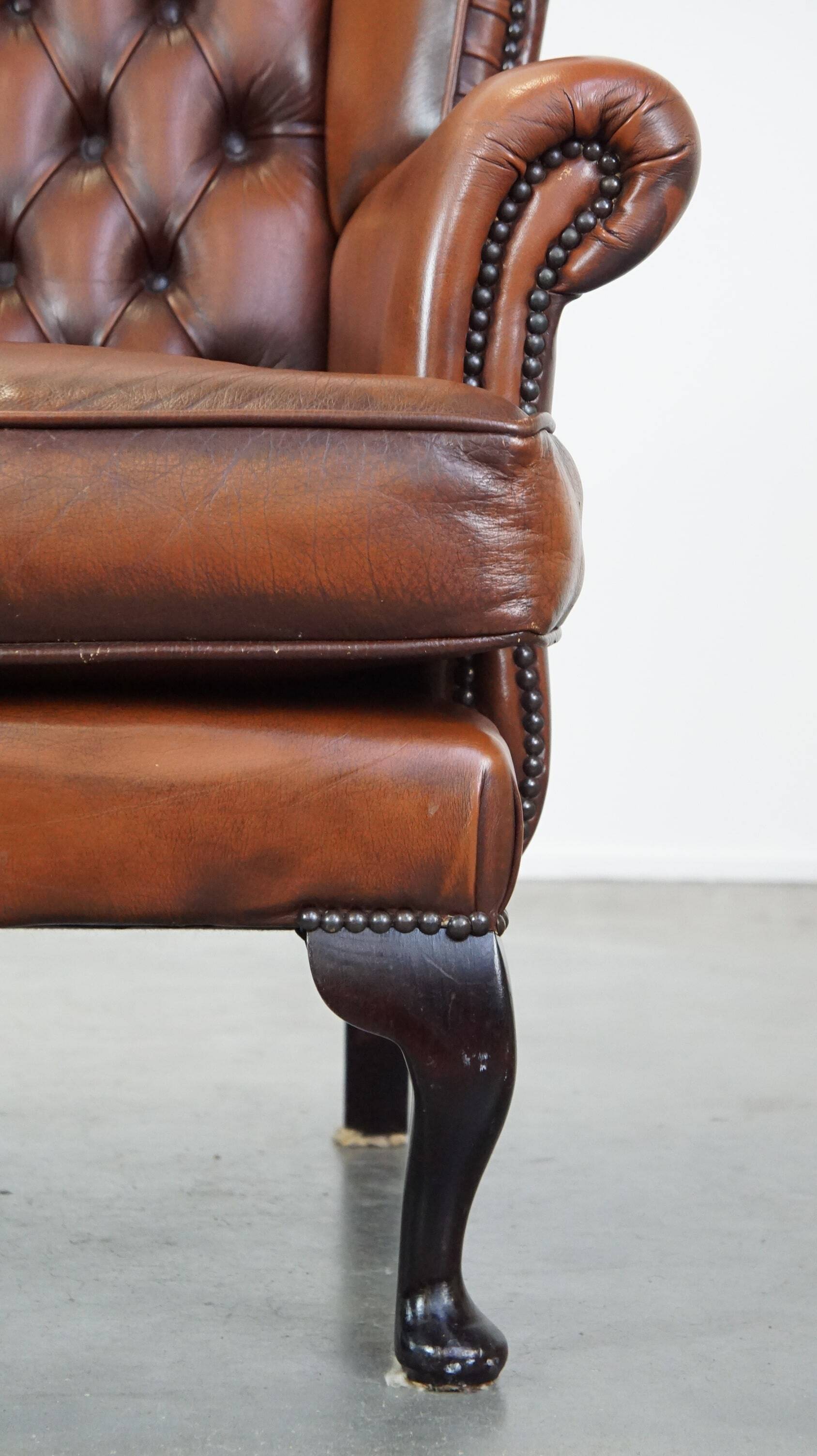 Brown leather wingback Chesterfield armchair