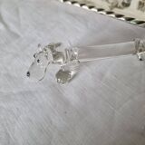 A charming set of 12 molded glass knives rests in the shape of a dog