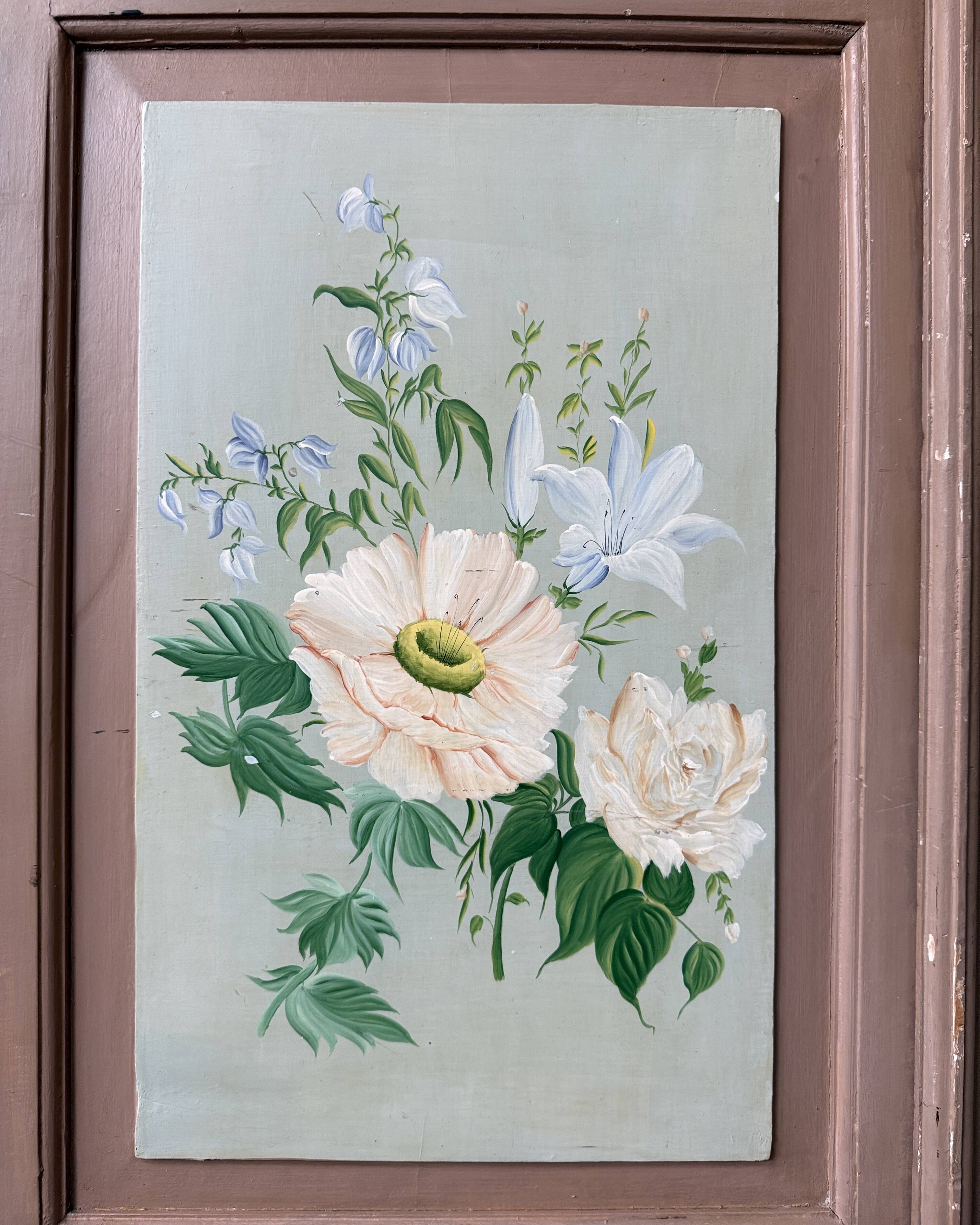 Large antique wardrobe painted with floral decoration.