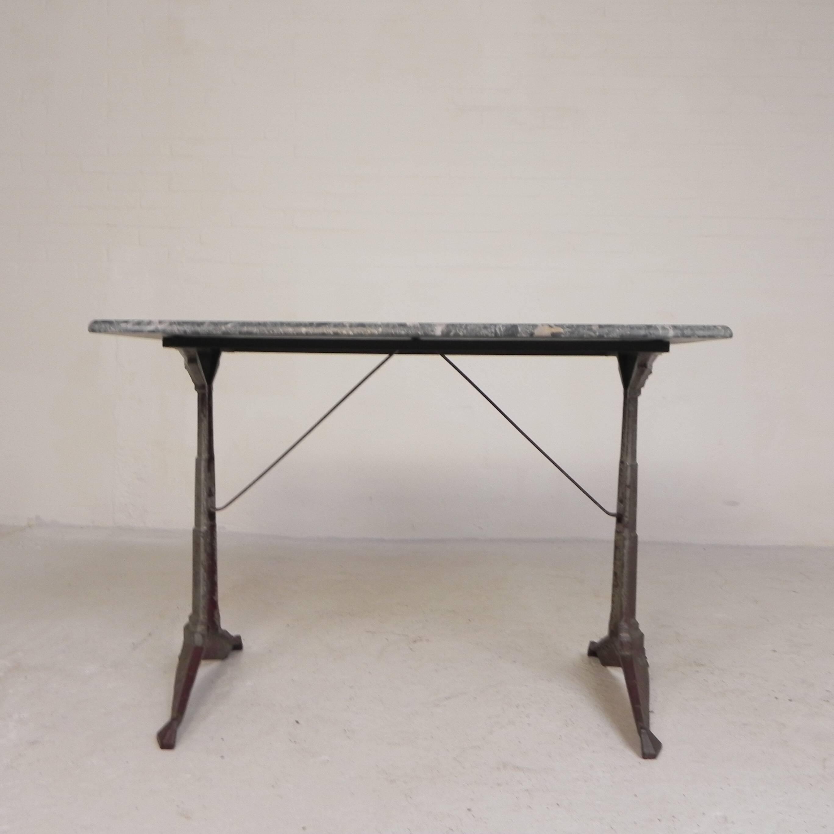 Bistro table with a marble top on a cast iron frame, 1930s.