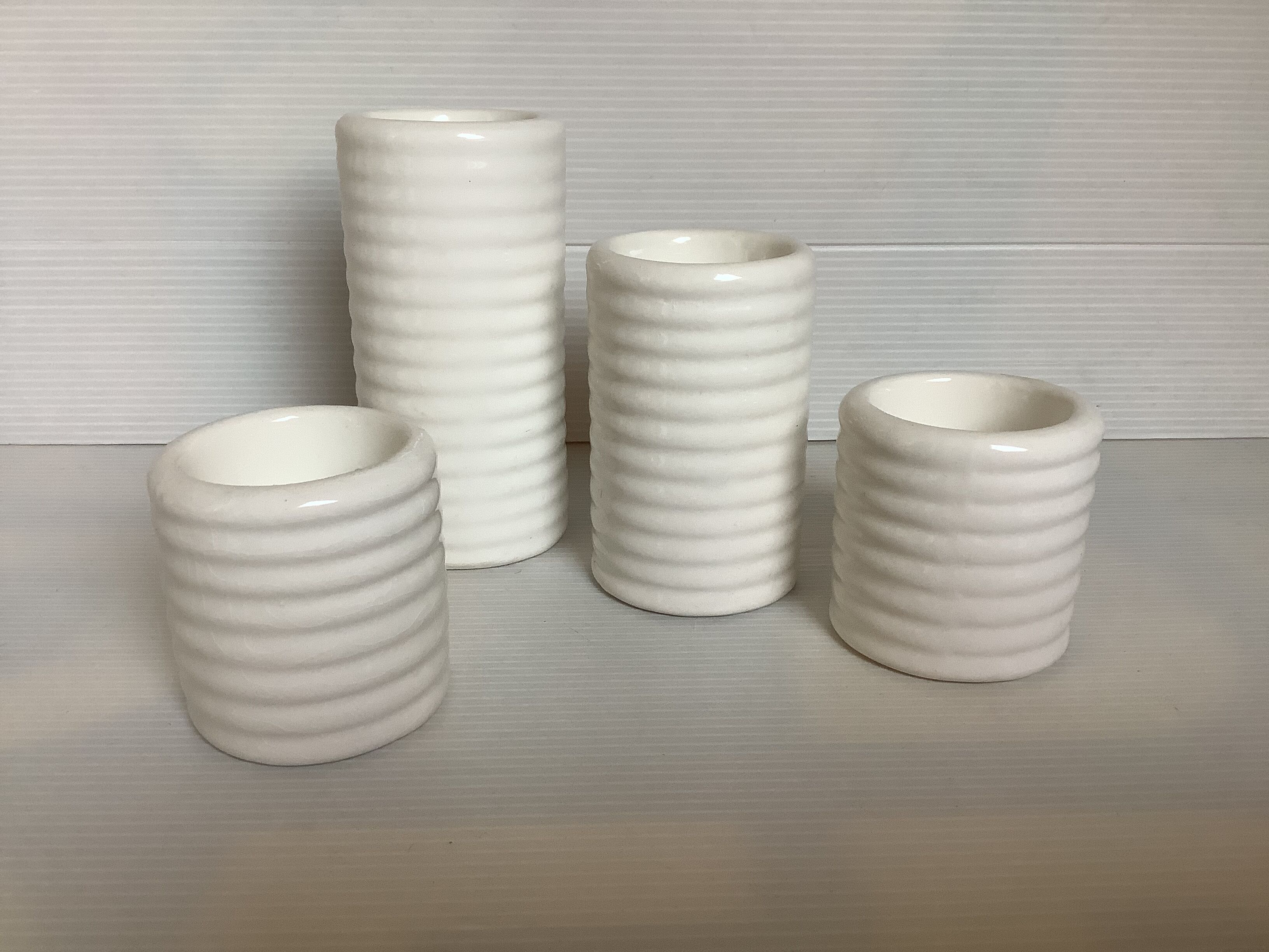 Four white earthenware candle holders