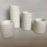 Four white earthenware candle holders