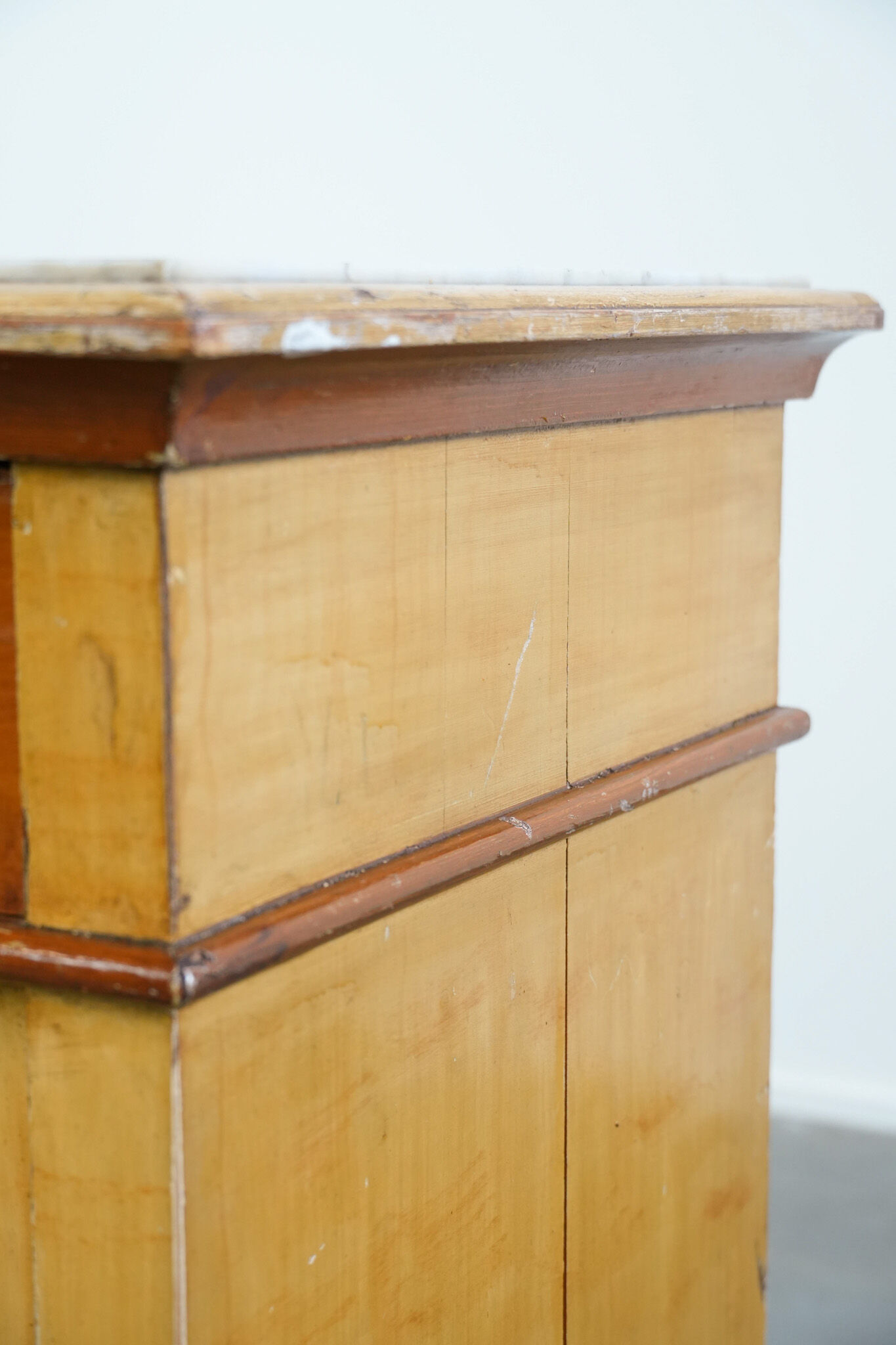 Antique wooden 1-door hallway/nightstand with a light marble top