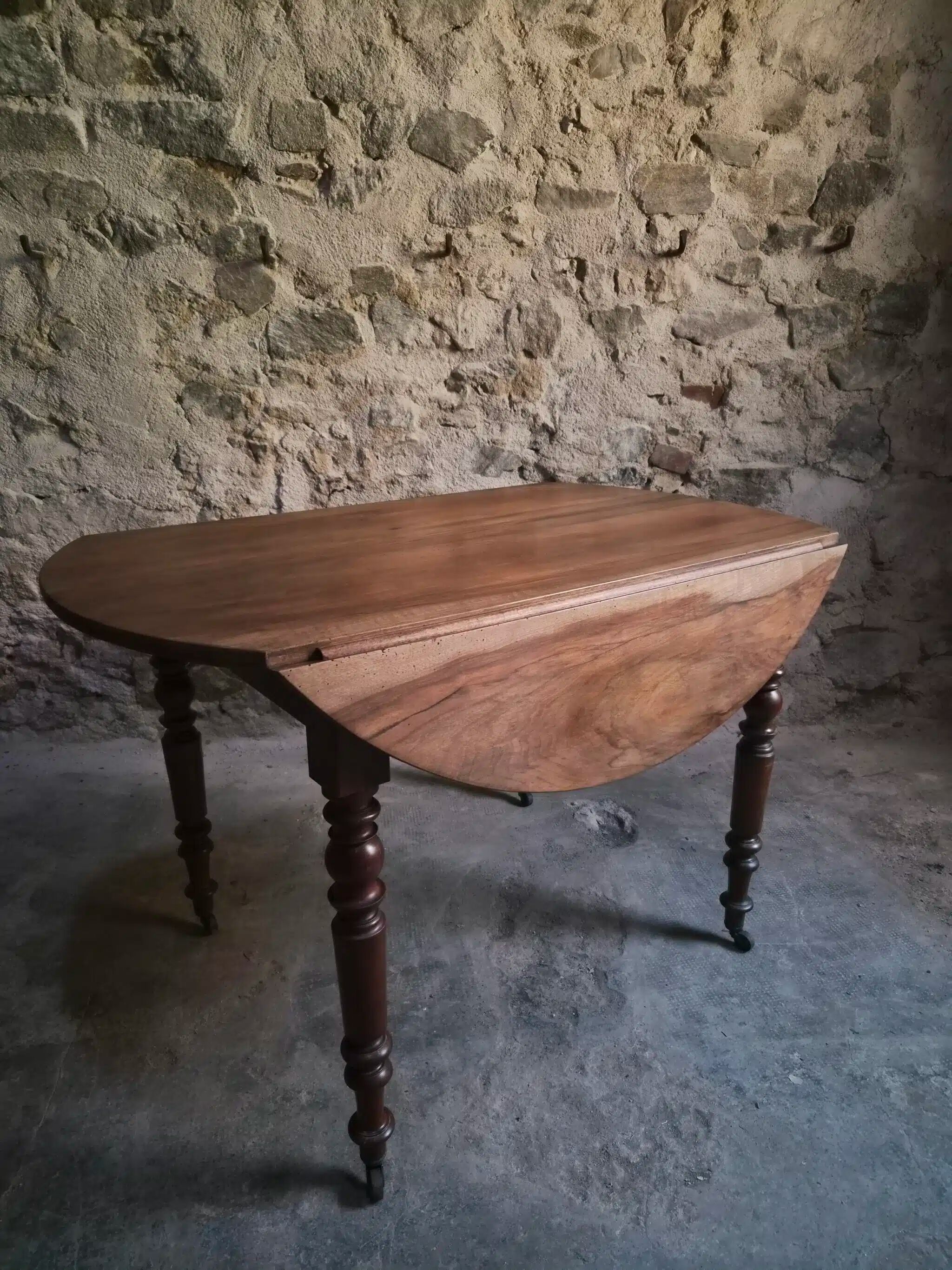 Antique drop-leaf dining table in walnut, France, circa 1900.