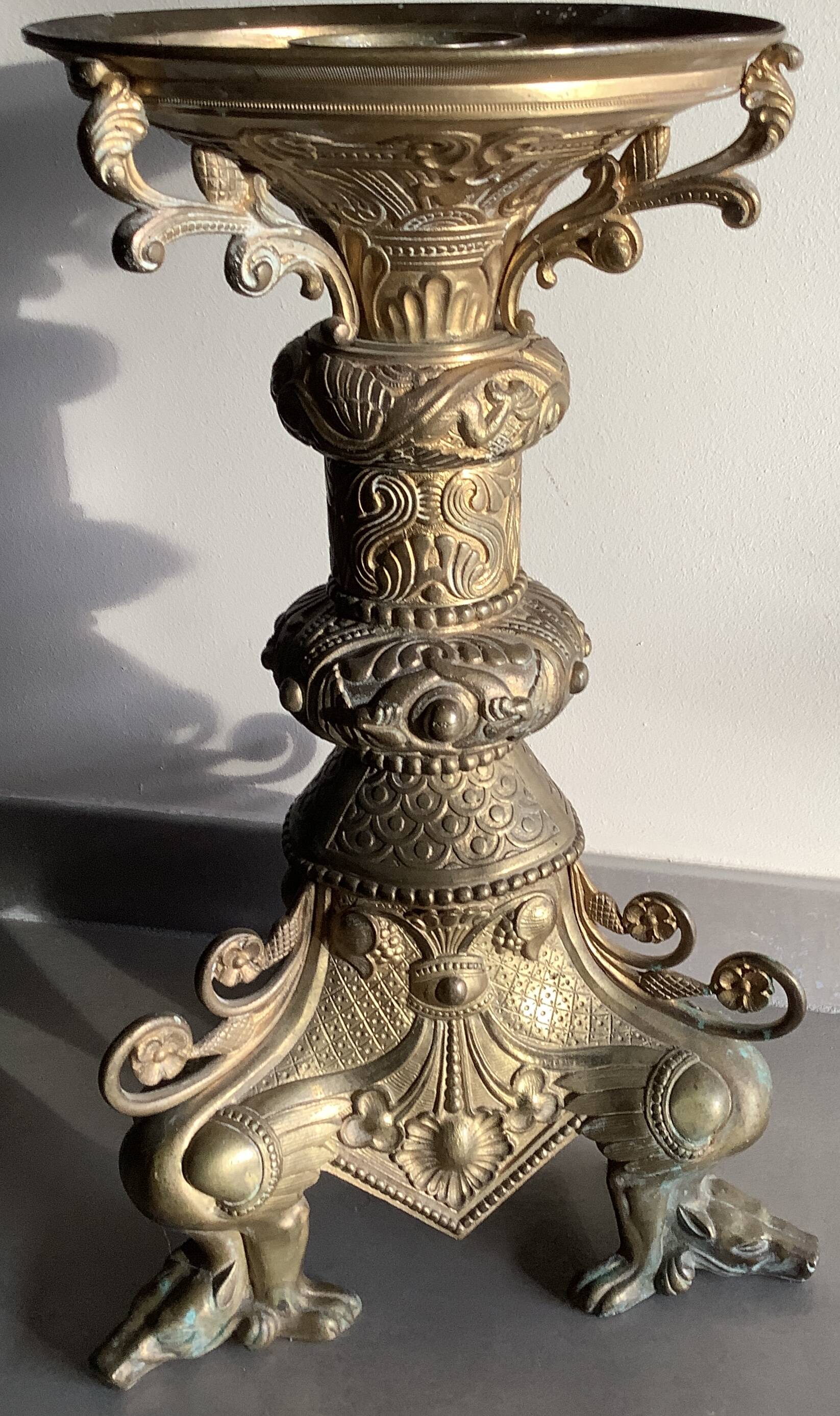 Large bronze candlestick with tripod and winged dog decoration, 19th century.