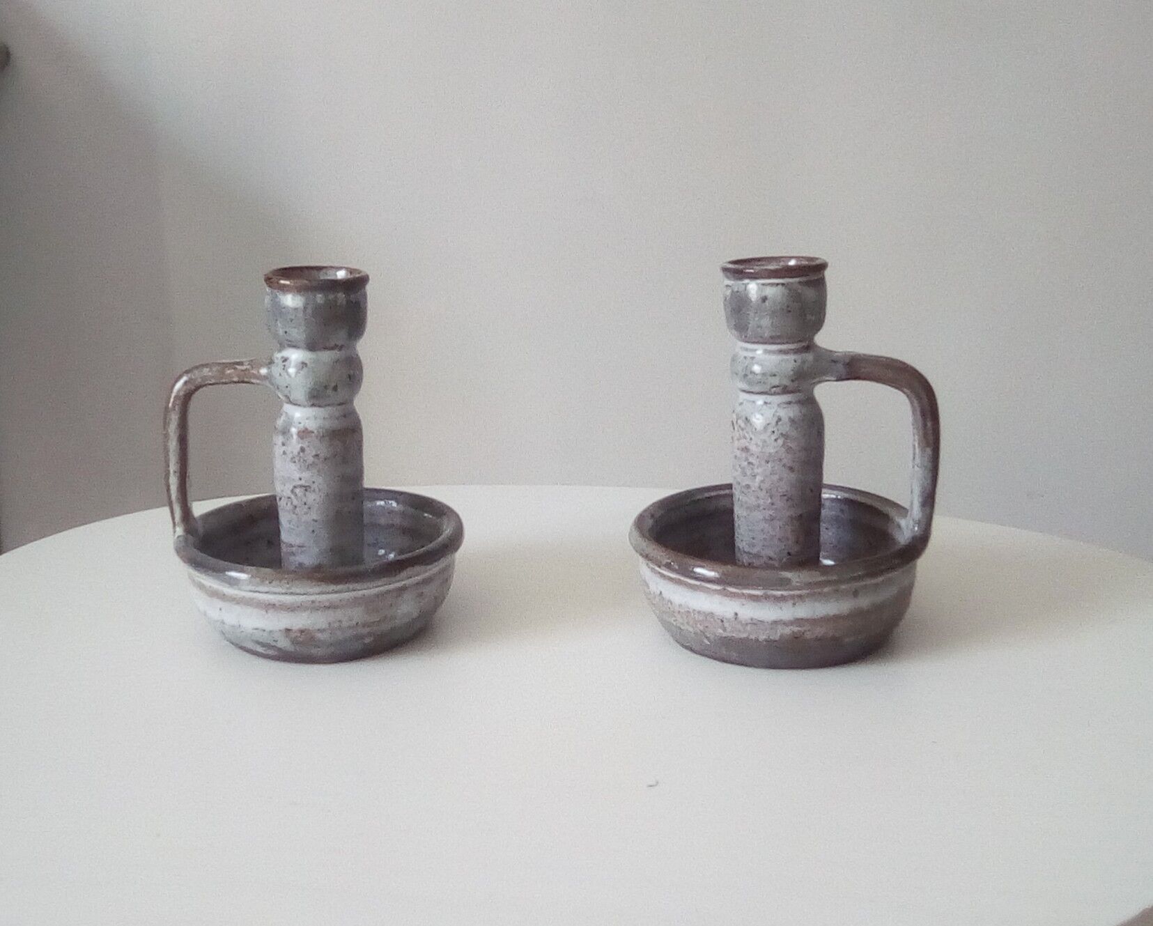 Pair of speckled sandstone candle holders