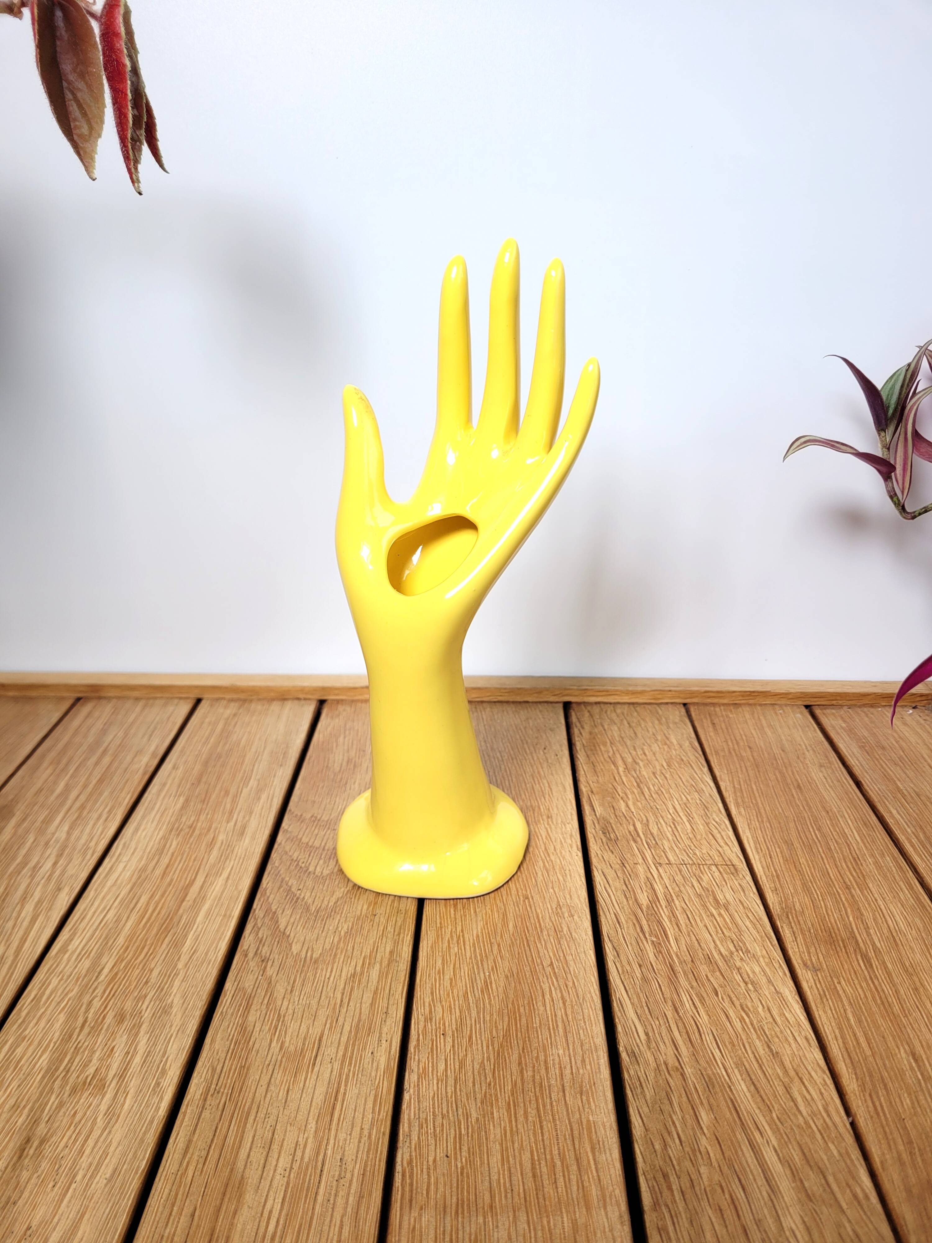 Hand wears ring and yellow soliflore