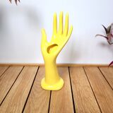 Hand wears ring and yellow soliflore