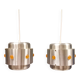 Two Space-Age hanging lamps, in silver-coloured aluminium with orange prisms.