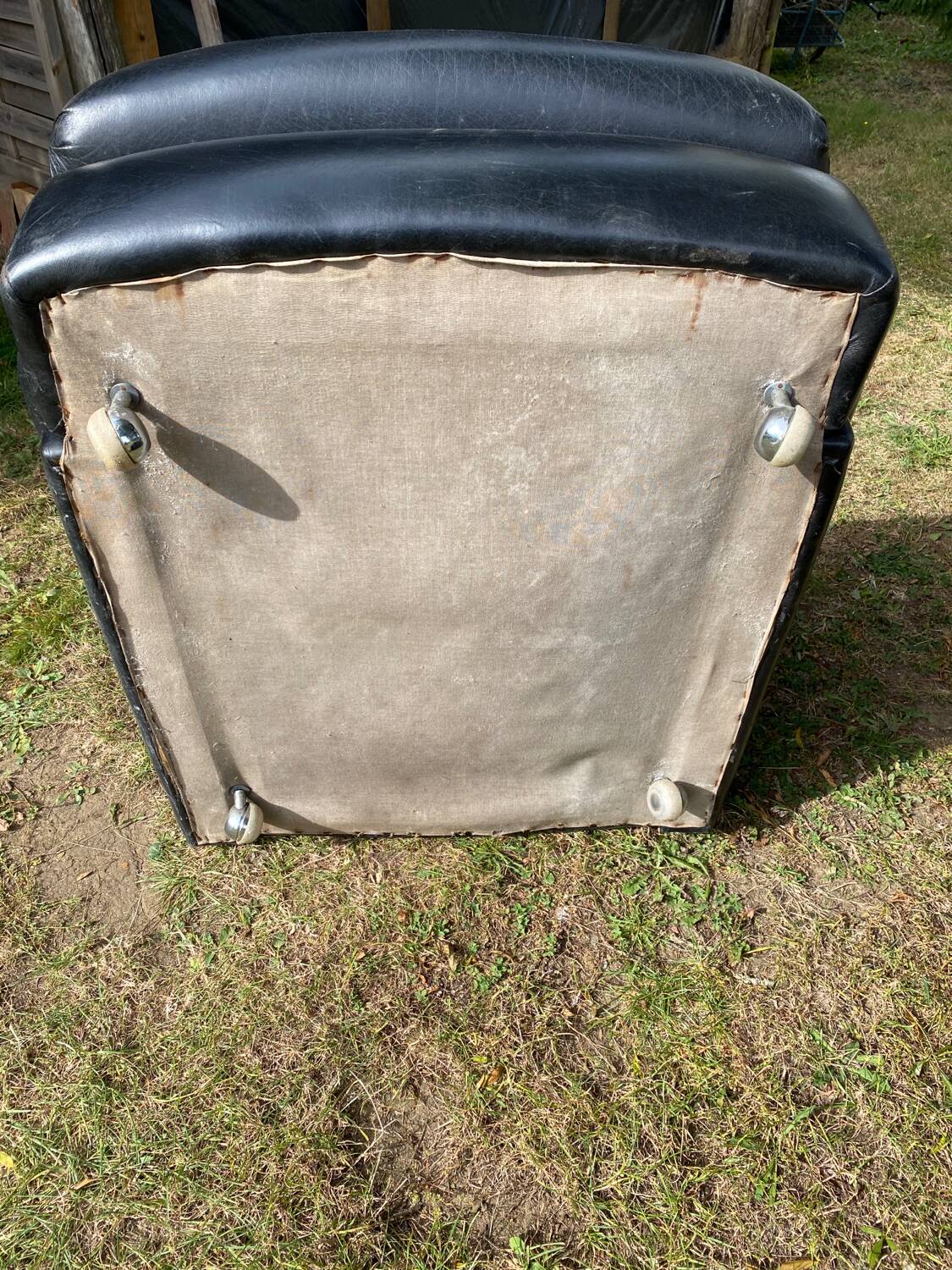 Pair of black imitation leather armchairs