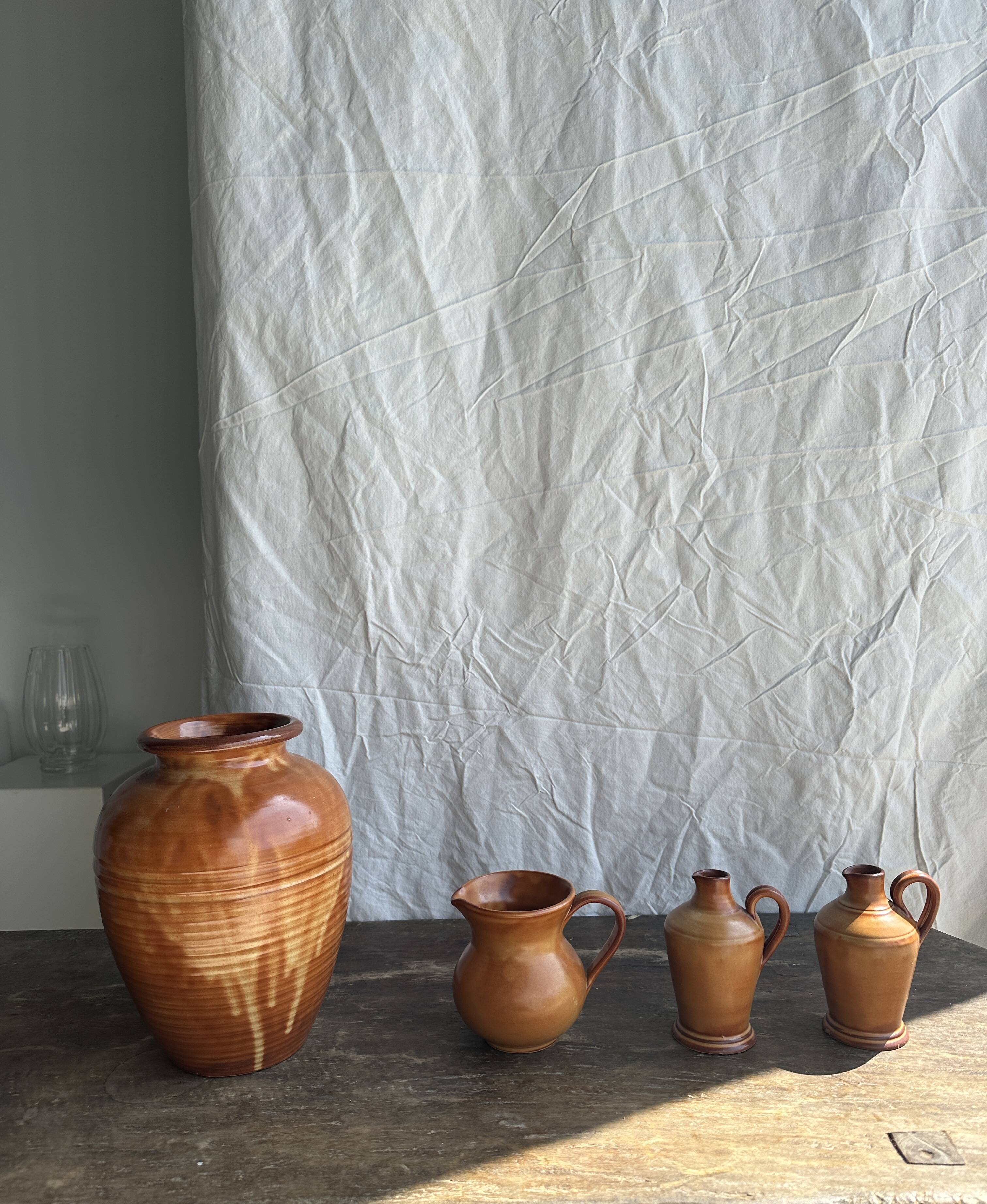 Pair of mini orange stoneware pitchers