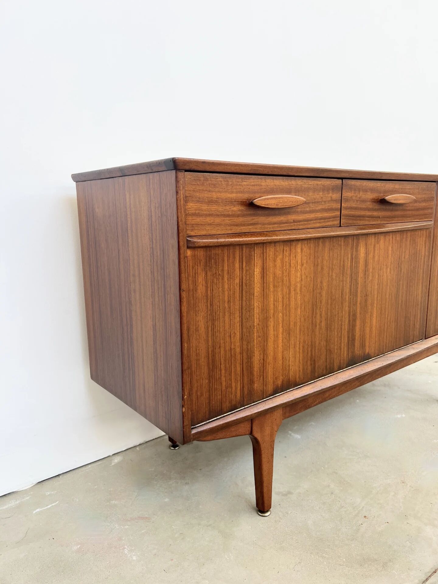 Teak Jentique sideboard — 1 door, 2 drawers & drop-down bar, England 1950s-60s