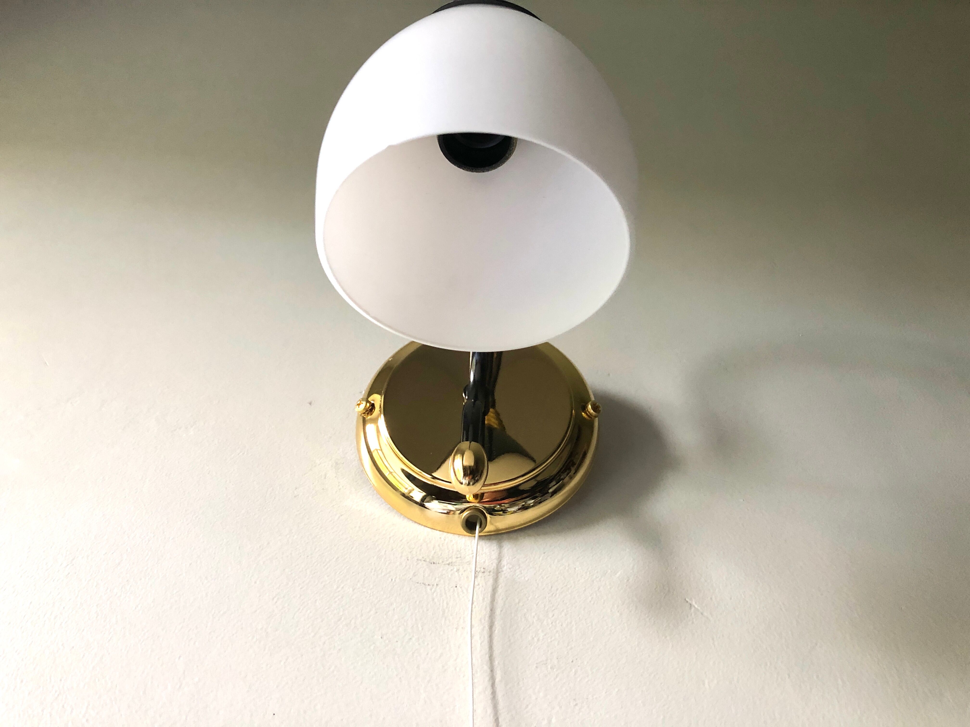 Black and gold wall light with white opaline flower, Italy 1990.