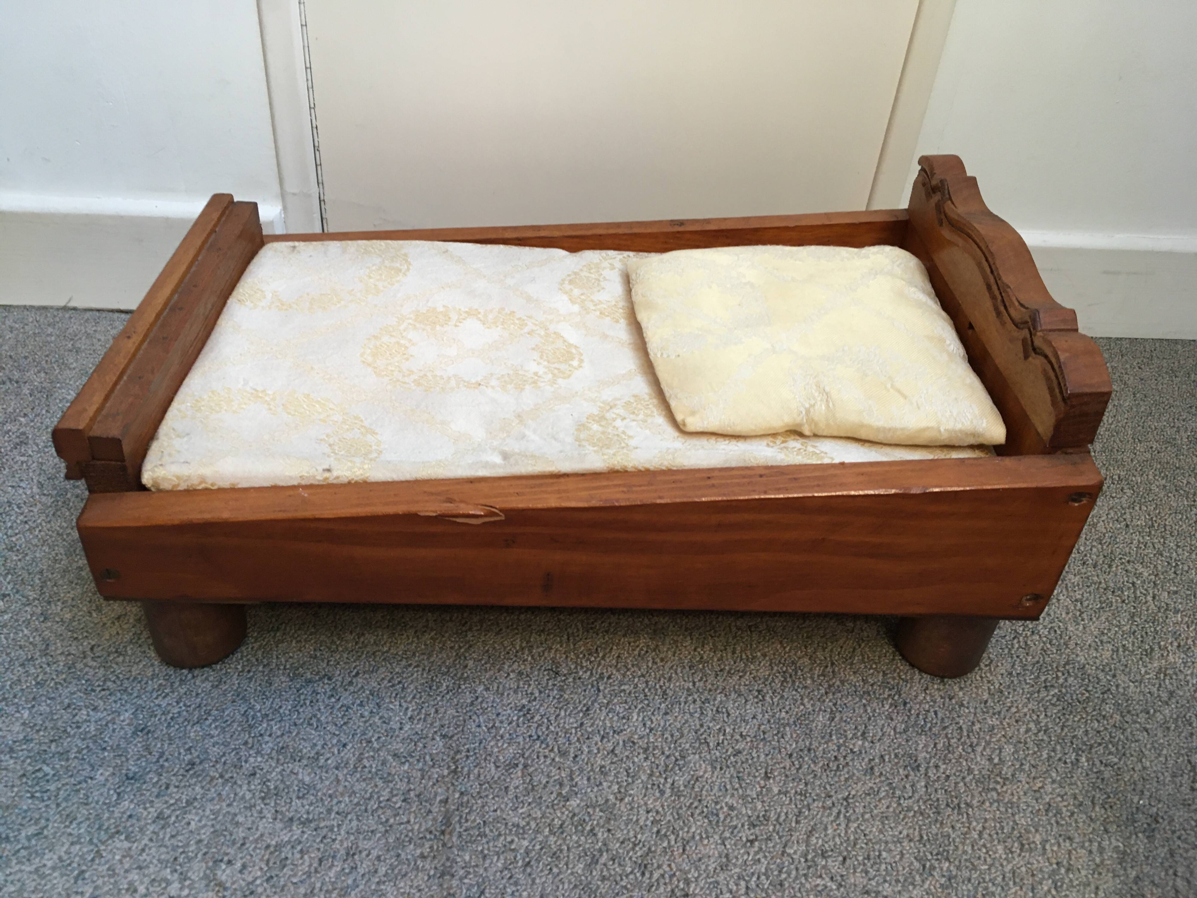 Old wooden bed for doll with mattress and pillow