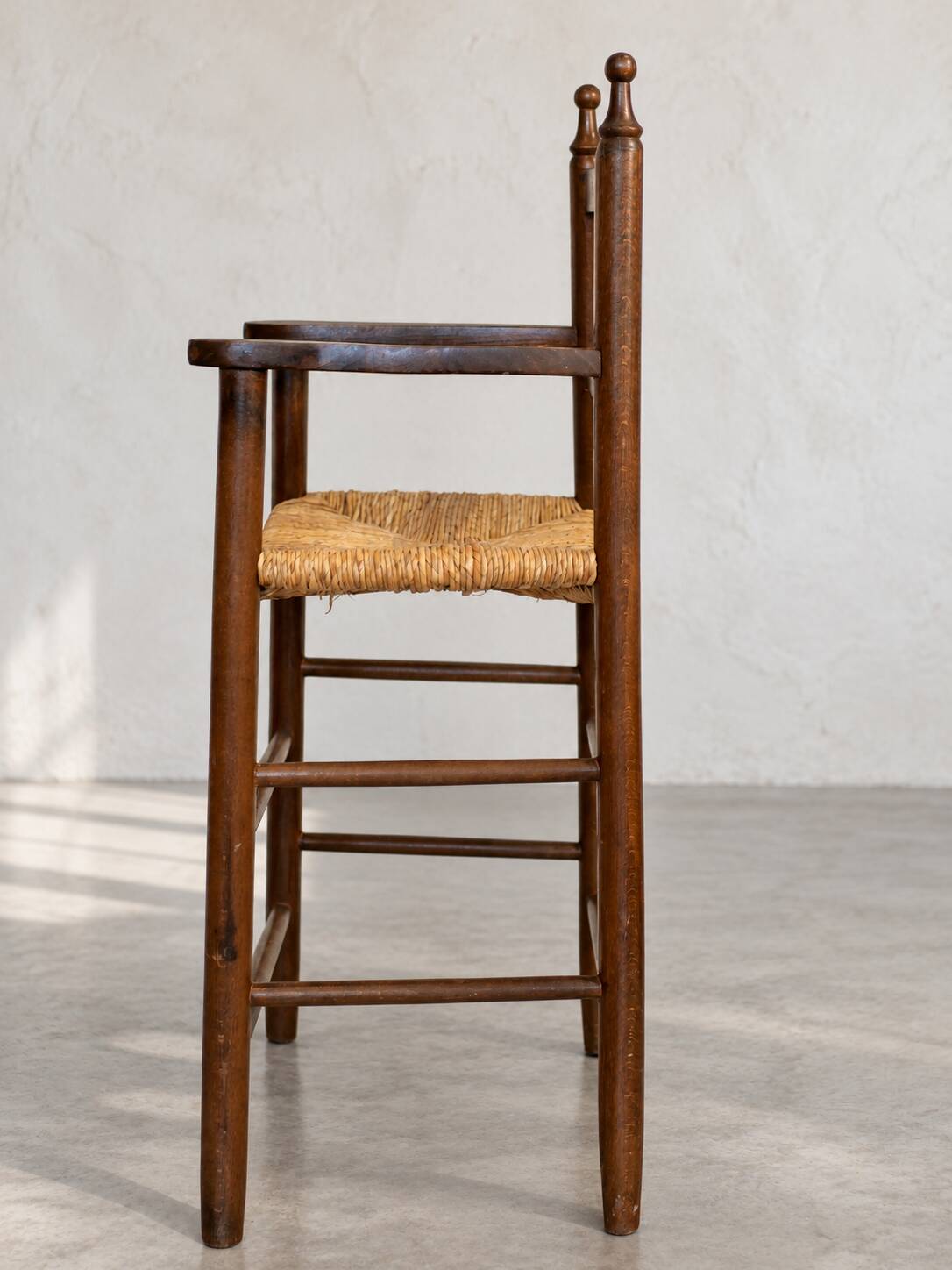 High chair made of straw and wood