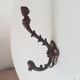 Antique wall coat hook from the 19th century in Victorian cast iron style.