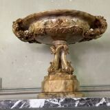 Alabaster bowl decorated with vine leaves on a base of three dolphins, circa 1880.