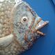 Vallauris ceramic wall sculpture of a relief fish on a blue plaque.