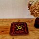 Vintage ceramic trivet with a 70s pattern.