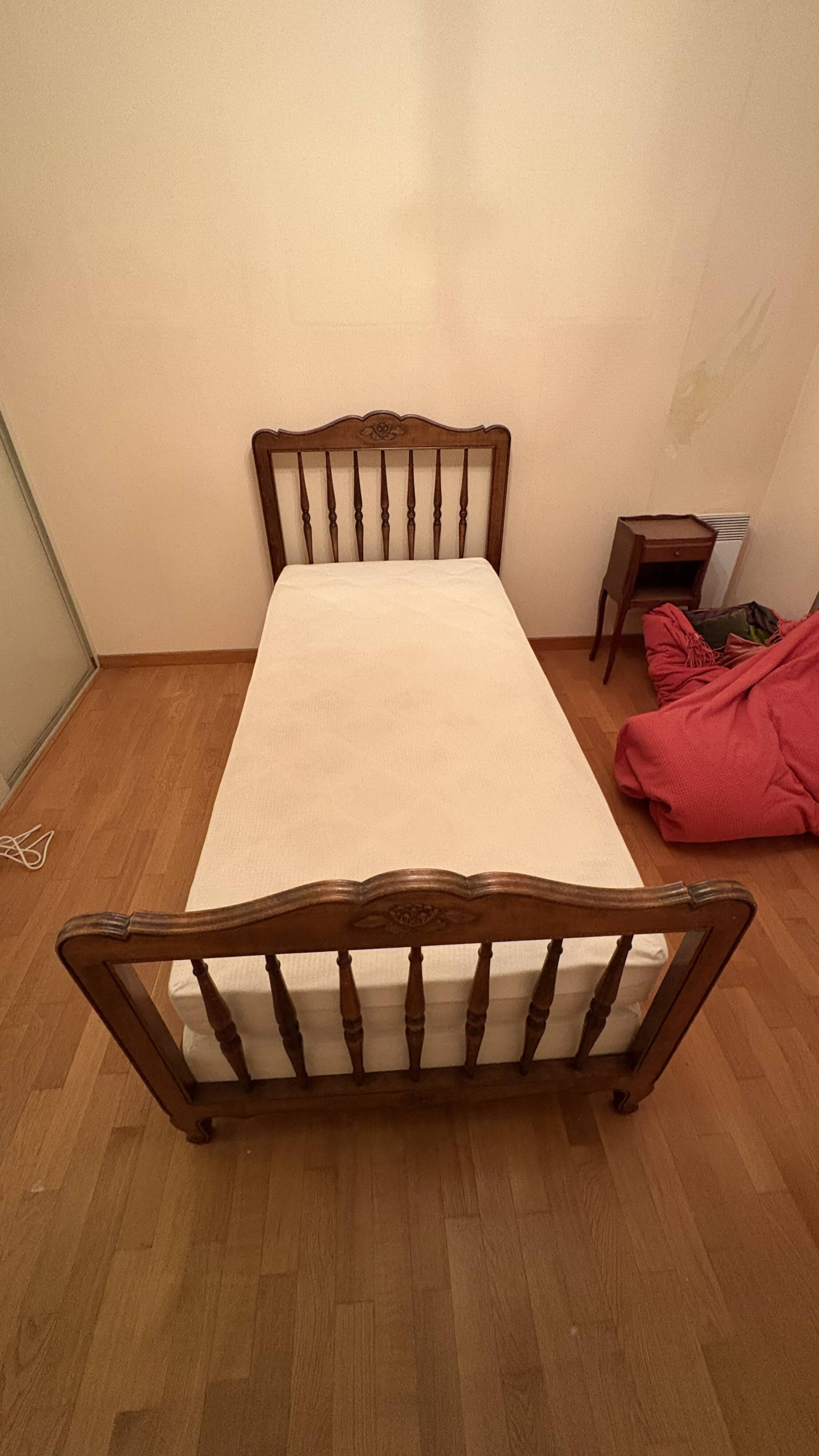 1 bed with a wooden frame and mattress