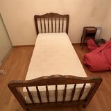 1 bed with a wooden frame and mattress