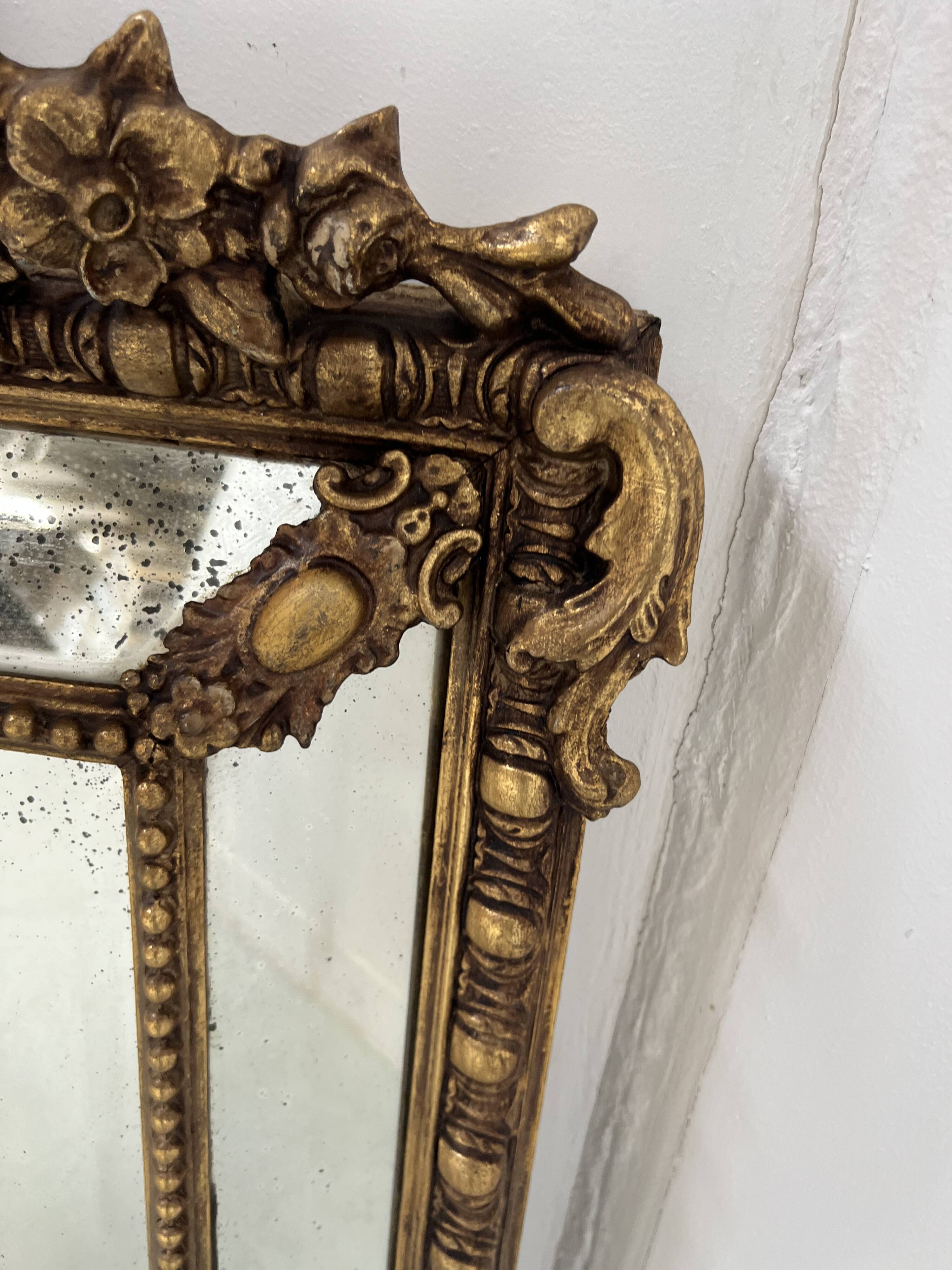 Louis XVI style mirror with parecloses in wood and gilded stucco, 19th century