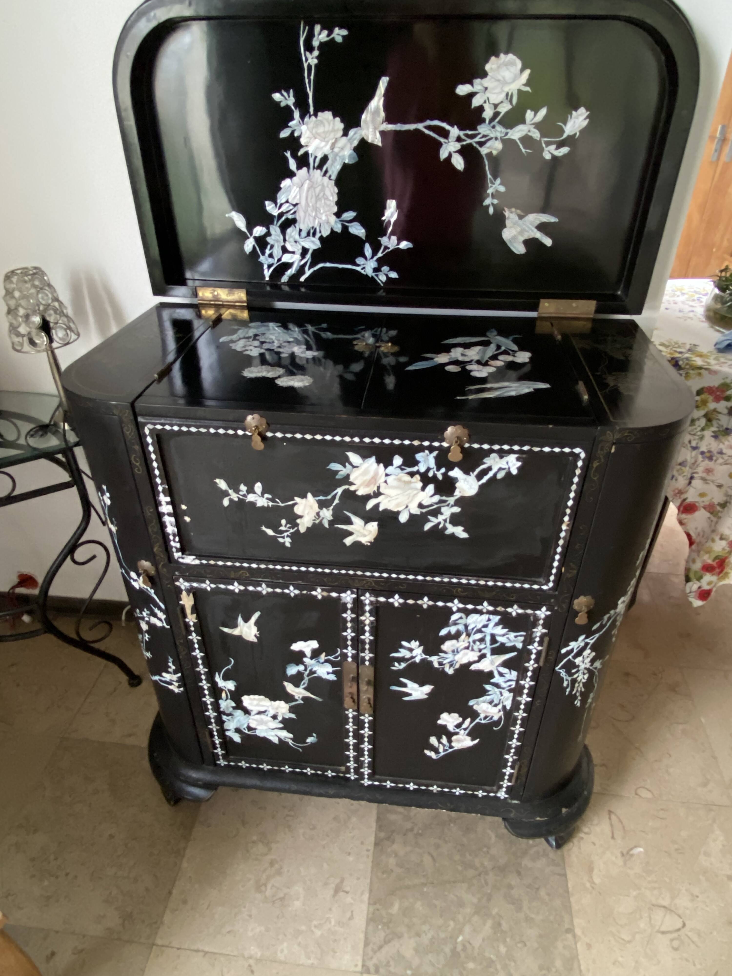 Black lacquered artisanal bar with mother-of-pearl inlays.