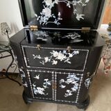 Black lacquered artisanal bar with mother-of-pearl inlays.