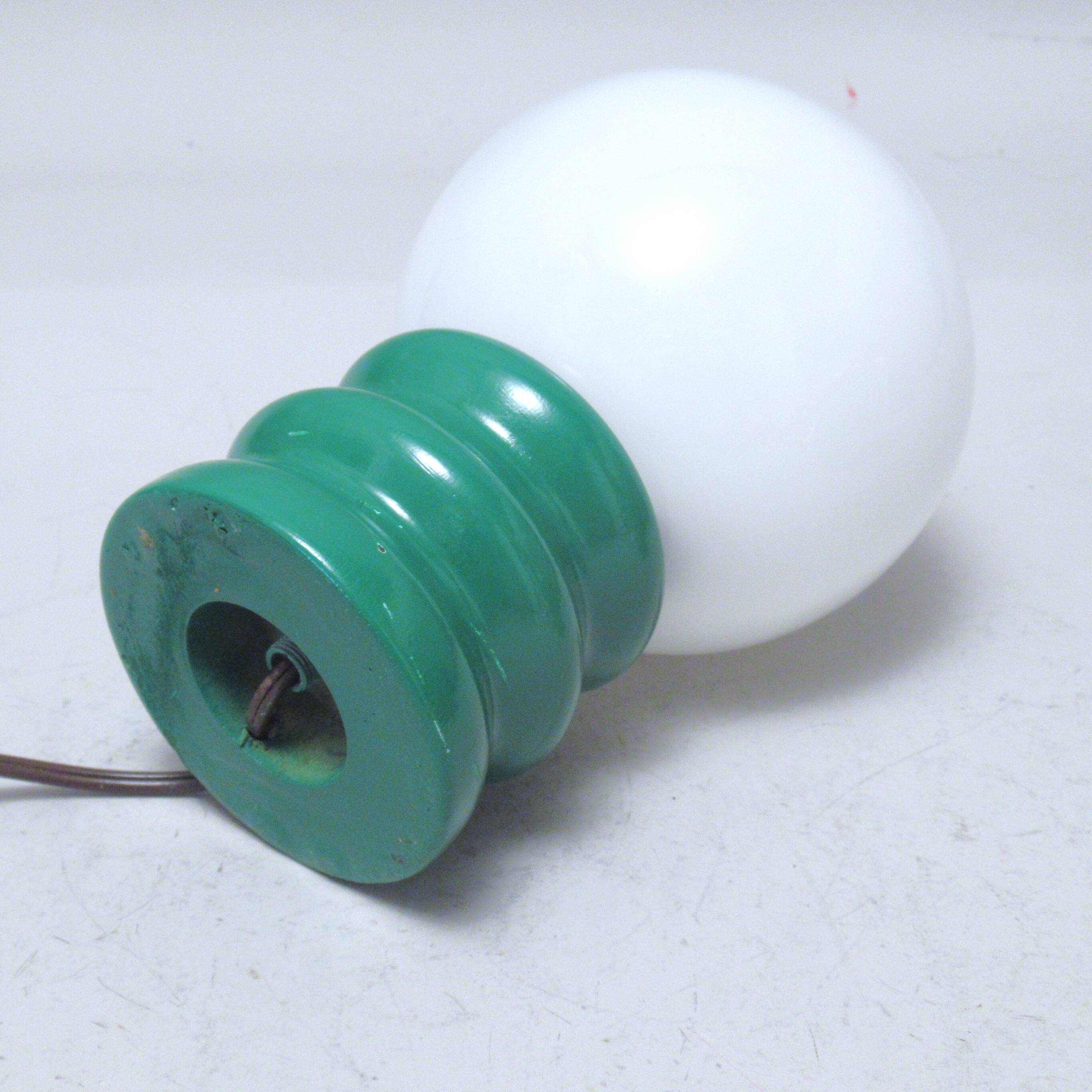 Green 1970s floor lamp with a globe shade.