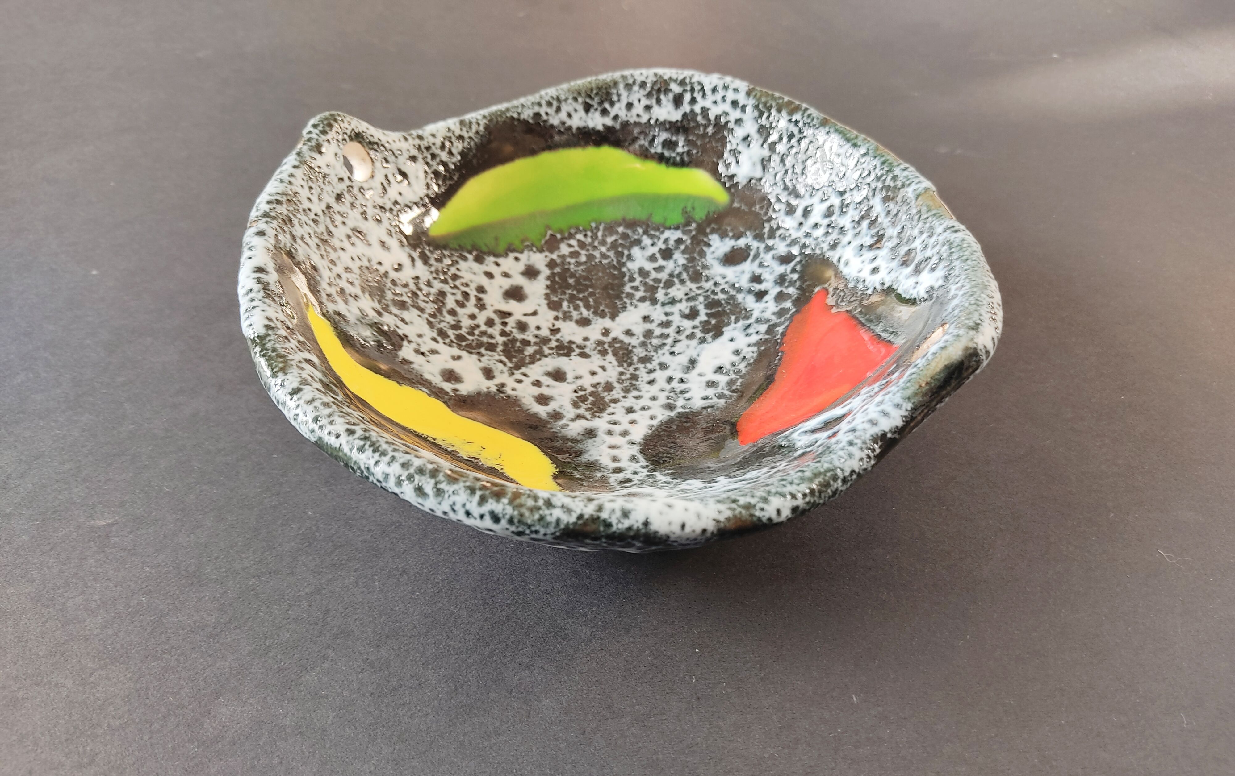 Empty black and white pocket with colored enamels