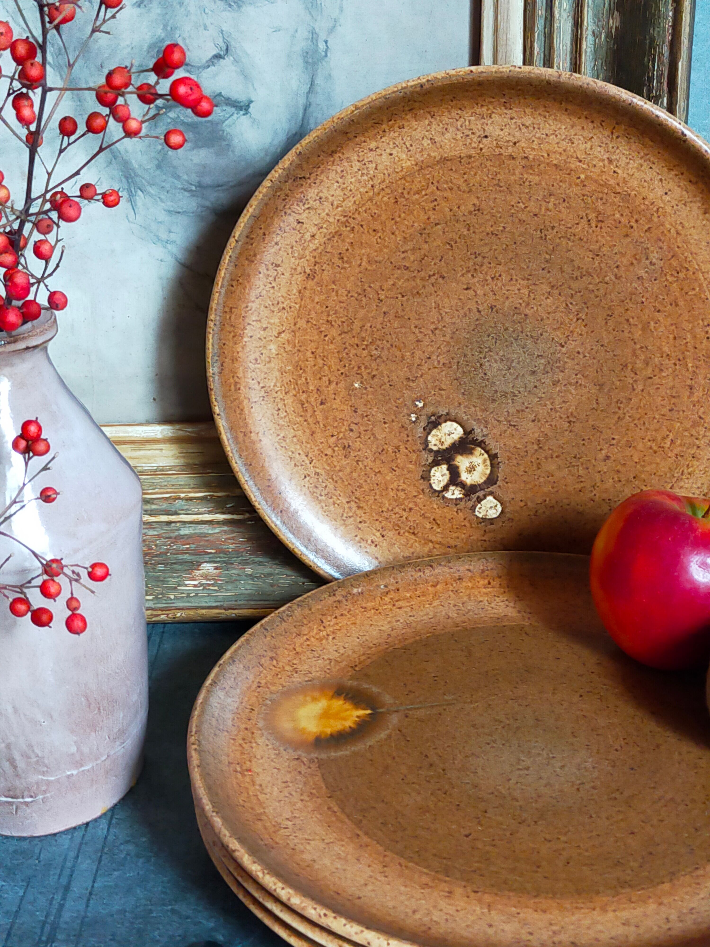Four vintage glazed stoneware potter's plates