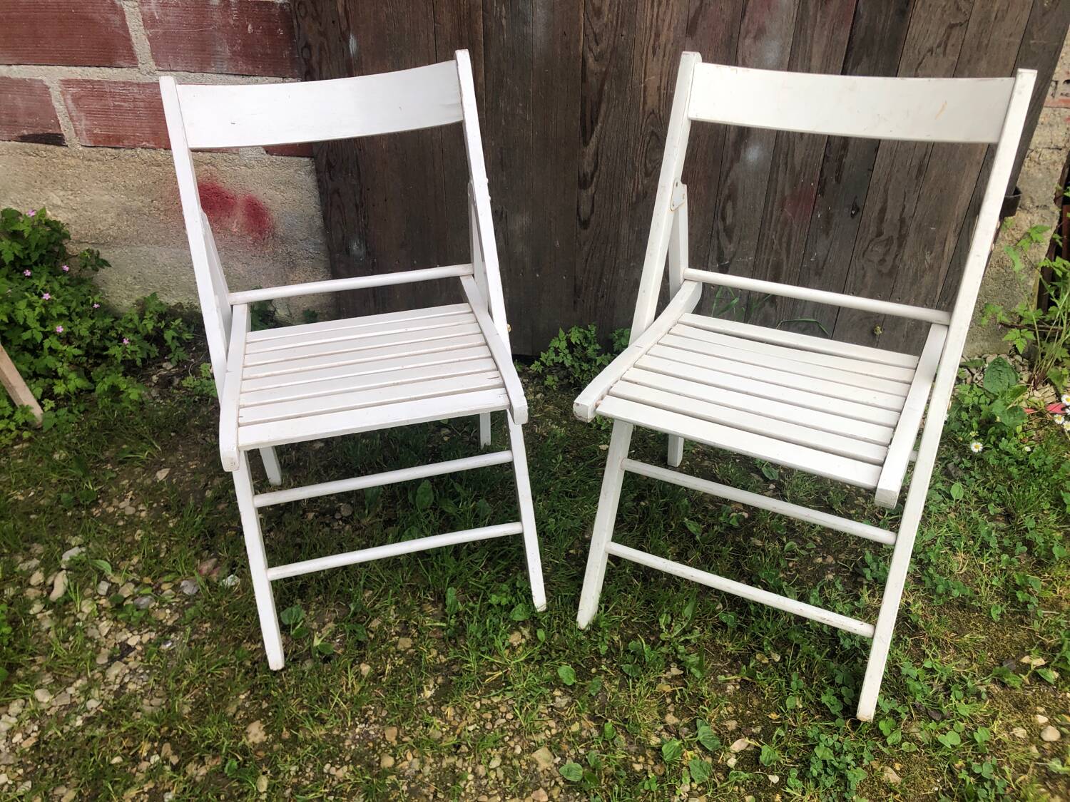 Pair of vintage white wooden folding chairs