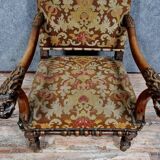 Renaissance armchair in carved walnut with lion head decoration