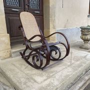 Curved wooden rocking chair with caning