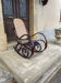 Curved wooden rocking chair with caning